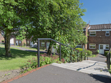 Small steps leading down to the properties in a communal garden