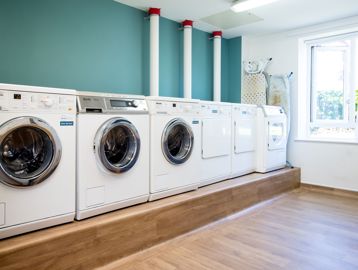 Row of appliances in a communal laundry room