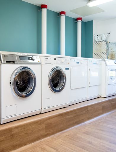 Row of appliances in a communal laundry room 