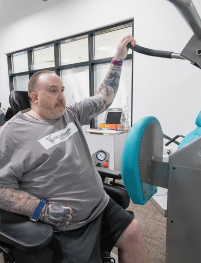 Chris, a Housing 21 resident, uses gym equipment as part of his physiotherapy