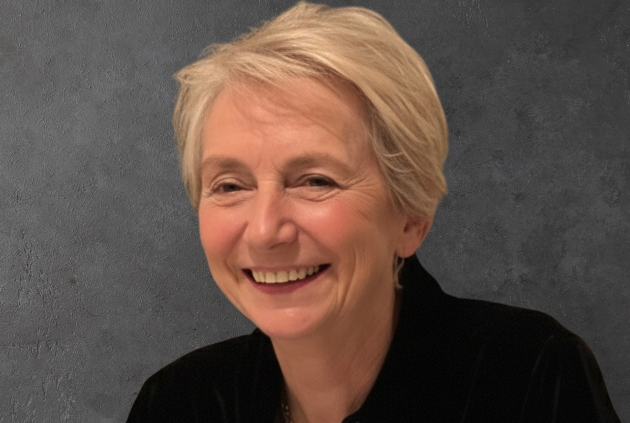 A woman looks into the camera