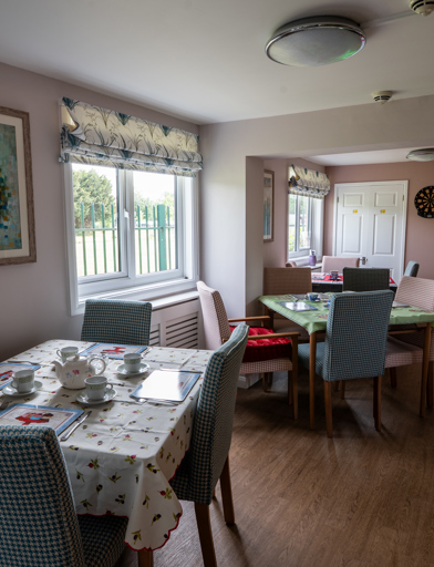 Dining room tables and chairs set up for afternoon tea 