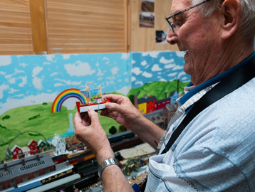 A resident showing off his model railway in the St Crispin hobby and craft room