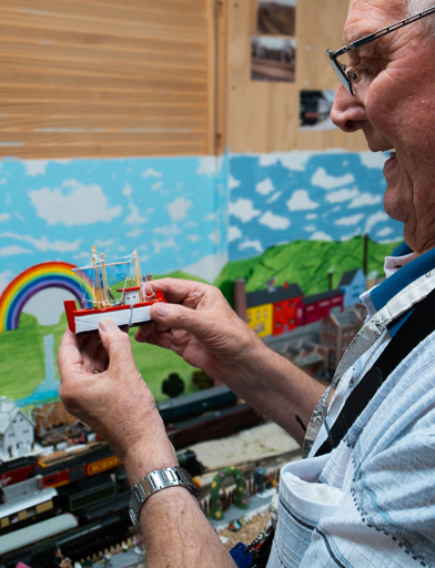 A resident showing off his model railway in the St Crispin hobby and craft room 
