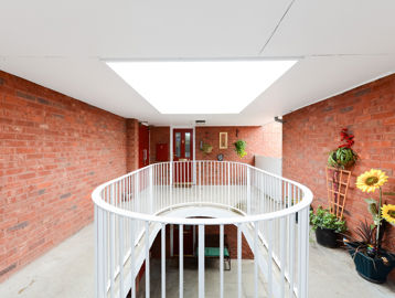 Communal hallway area with potted plants at Amos Court