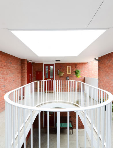 Communal hallway area with potted plants at Amos Court