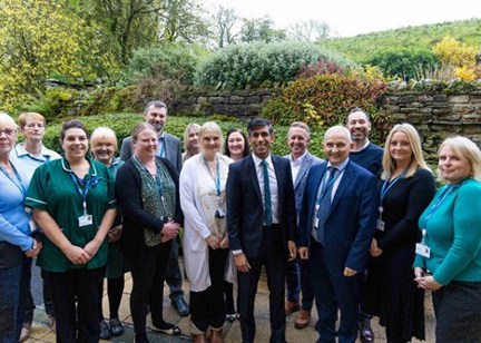 rime Minister Rishi Sunak standing outside with representatives from Sycamore Hall Court and North Yorkshire Council