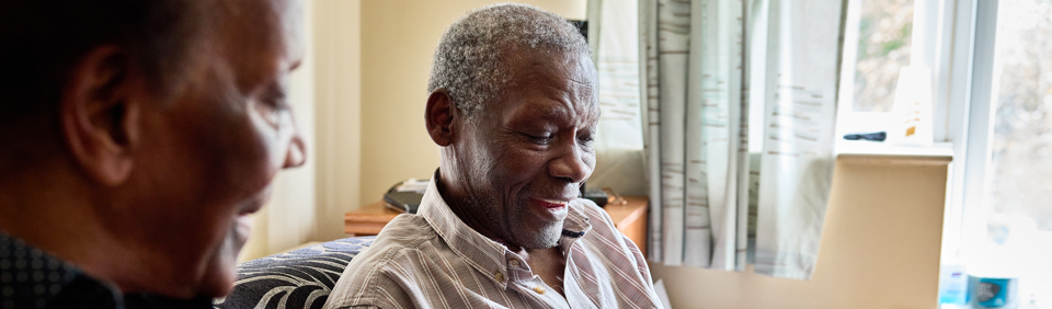 Resident smiling typing on a mobile phone 