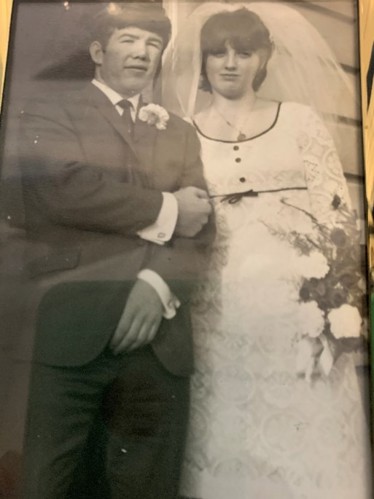 Housing 21 residents Elaine and Richard standing outside on their wedding day in 1964.