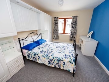 A furnished double bedroom inside Mere View 