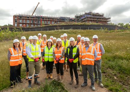 Housing 21 colleagues and partners in a group standing in front of a new extra care scheme 