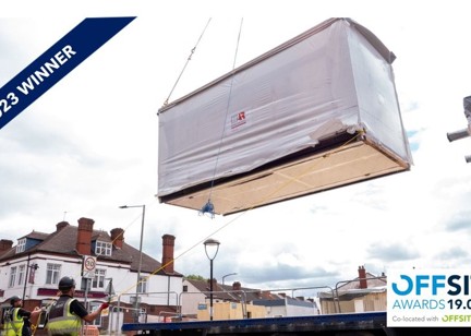 A banner showing that Patent House scheme are 2023 winners of the offsite awards. The image depicts construction workers lowering a large unit with ropes.