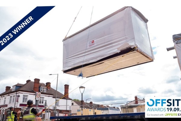 A banner showing that Patent House scheme are 2023 winners of the offsite awards. The image depicts construction workers lowering a large unit with ropes.