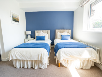 Hotel style guest room with two single beds