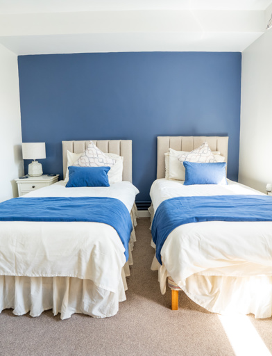 Hotel style guest room with two single beds 