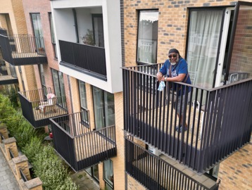A resident on the balcony at Cheviot Gardens