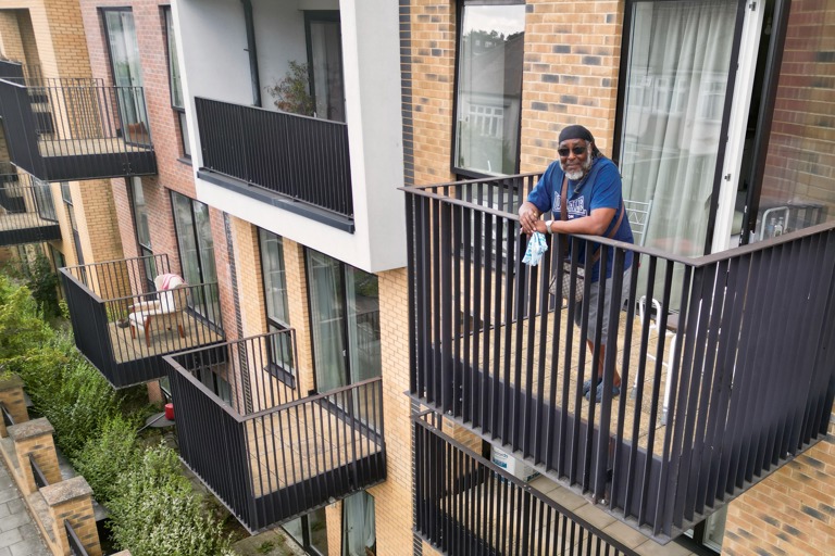 A resident on the balcony at Cheviot Gardens