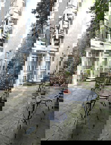 Small communal patio area with table and seating