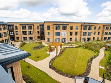 A drone shot of the gardens outside of Poppy Gardens with large grassed and landscaped areas