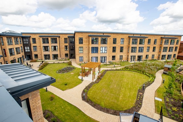 A drone shot of the gardens outside of Poppy Gardens with large grassed and landscaped areas