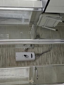 A shower unit with an accessible shower seat
