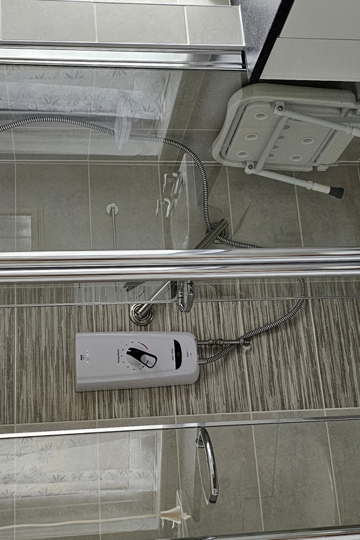 A shower unit with an accessible shower seat