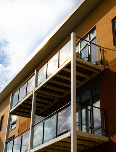 Looking up at some balconies on a bright day with blue skies 