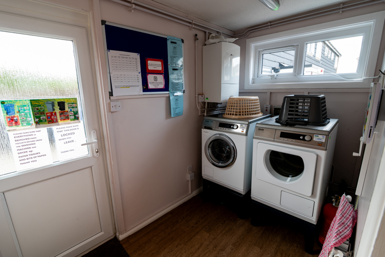 Small laundry room with a washing machine and dryer