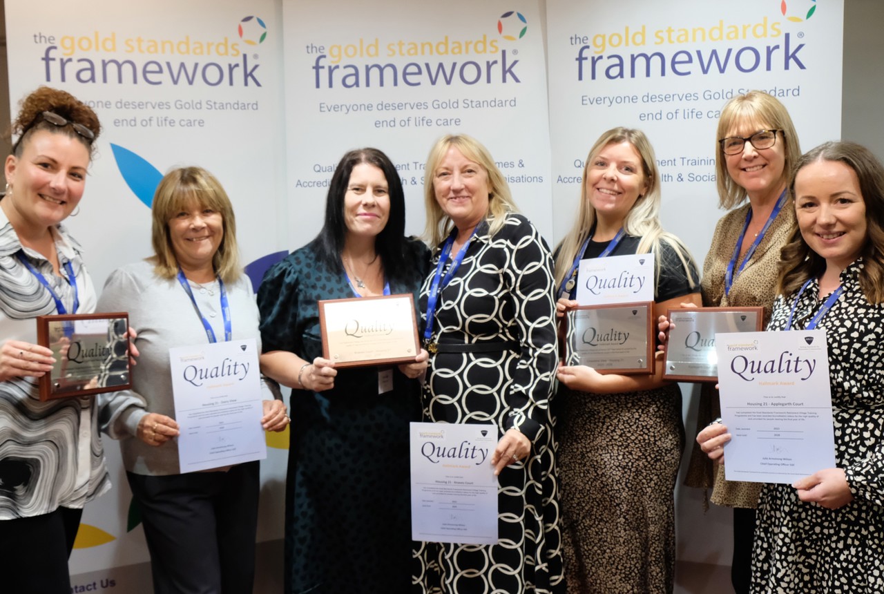 Housing 21 employees holding certificates for achieving Gold Standards Framework’s Quality Hallmark Award.