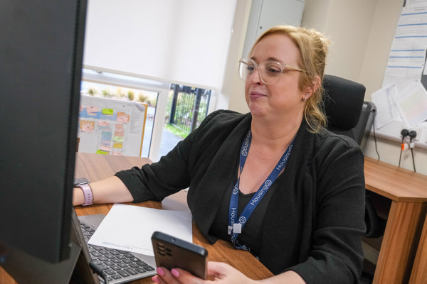 Image of Sam, Local Housing Manager, at her desk