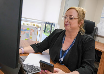 Image of Sam, Local Housing Manager, at her desk