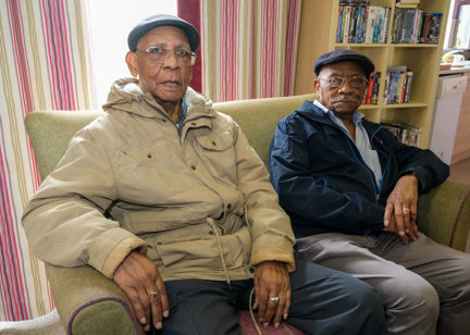Two brothers who are residents sitting down in a living room