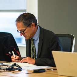 Chief Executive, Bruce Moore, writes in a notebook during a meeting