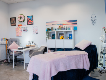 A massage bed and treatment room with relaxed and colourful furnishings