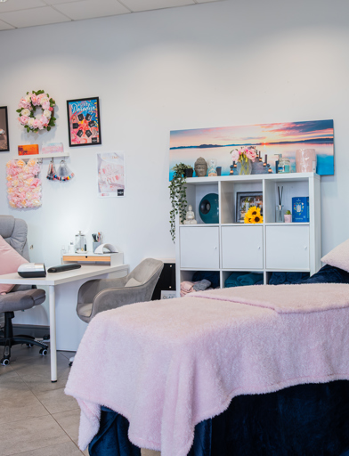 A massage bed and treatment room with relaxed and colourful furnishings 