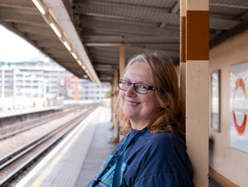 Jane, a resident at Minterne Apartments smiling into camera waiting for the underground
