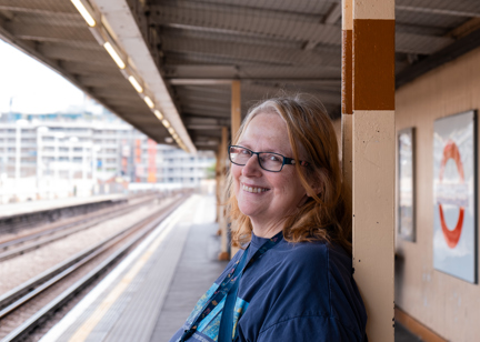 Jane, a resident at Minterne Apartments smiling into camera waiting for the underground