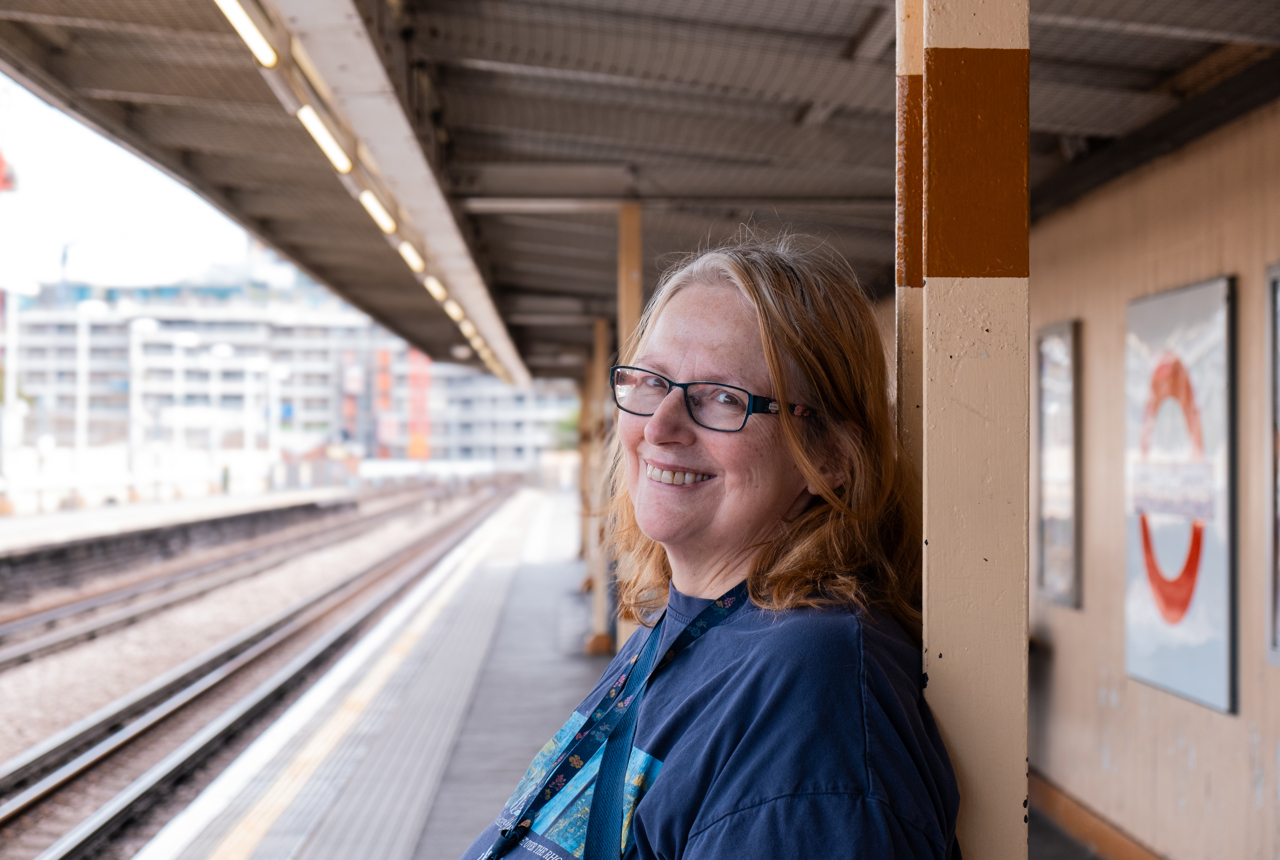 Jane, a resident at Minterne Apartments smiling into camera waiting for the underground
