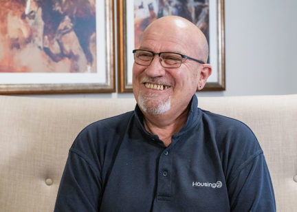 A man in glasses smiling