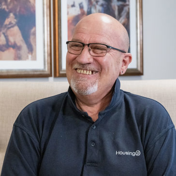 A man in glasses smiling