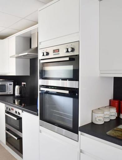 A modern, white kitchen in an apartment 