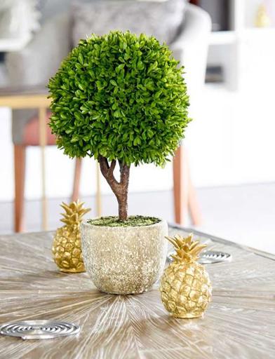 A table with a decorative tree and drinks coasters on top 