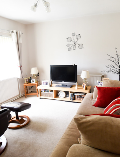 Living room in a residents' lounge with sofa, armchair and TV on a small unit
