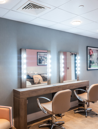 Beauty salon with soft seating and mirrors 