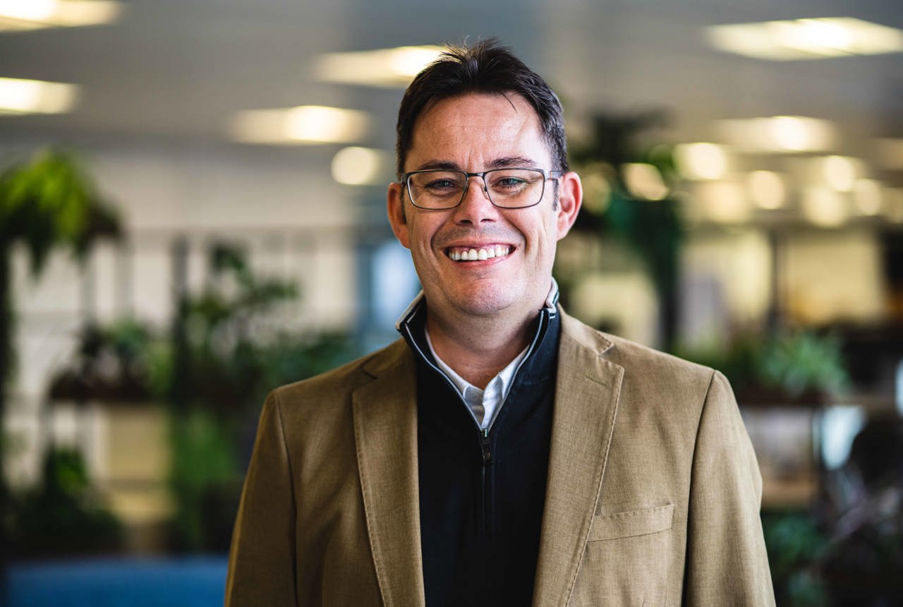 A man smiles at the camera