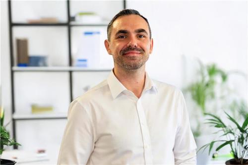 Man in white shirt smiling