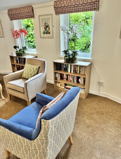 Newly decorated communal lounge with arm chairs 