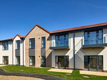 Exterior image of Filey Fields with a walk way and grass