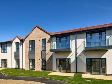 Exterior image of Filey Fields with a walk way and grass