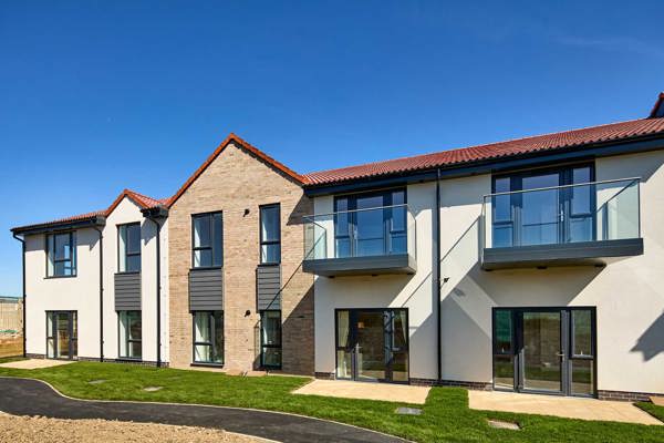Exterior image of Filey Fields with a walk way and grass